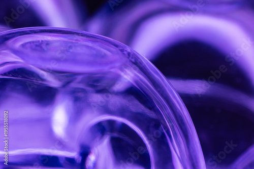 Abstract composition of upside down plastic egg carton reflecting blue light from below.