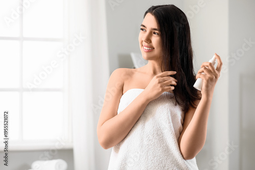 Young woman applying hair s...