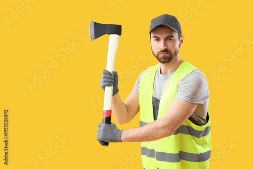 Male worker with ax on yell...