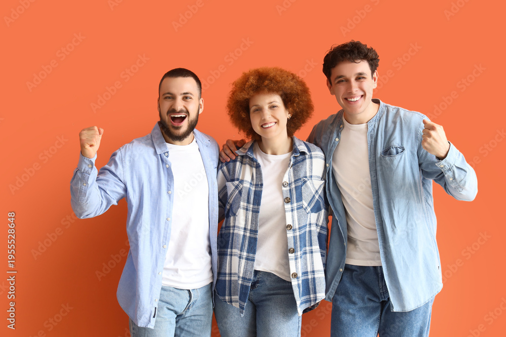 Obraz premium Group of young friends hugging on orange background