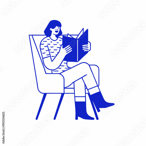 A woman relaxes in a chair deeply engrossed in reading a book