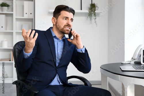 Angry businessman talking b...