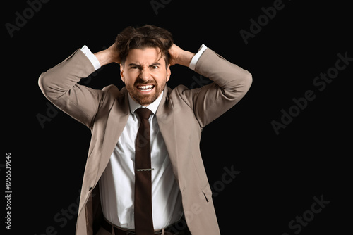 Angry businessman on black ...