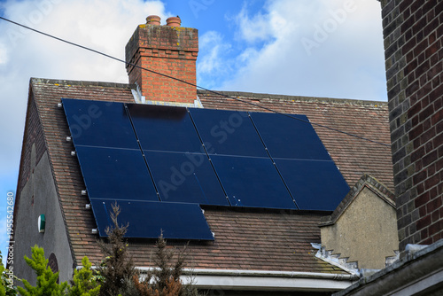 House roof with solar panels generating renewable energy UK