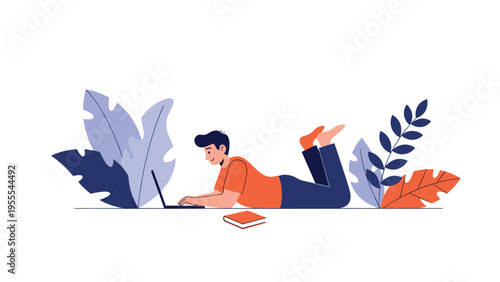 Young man lying comfortably on the floor while working on his laptop computer with decorative leaves in the background of a simple scene.