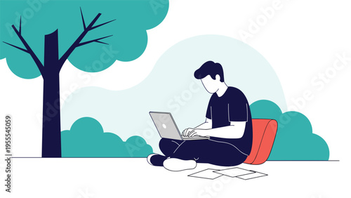 Young man enjoys the freedom of remote work by sitting on the grass under a large tree and working on his laptop.