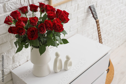 Vase with beautiful red ros...