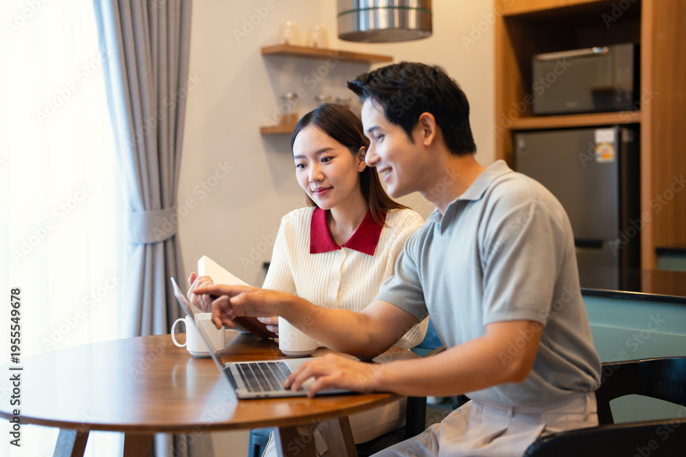 Fototapeta premium Happy young woman and man enjoying romantic family time in modern apartment. Married couple spending free weekend time together at home.