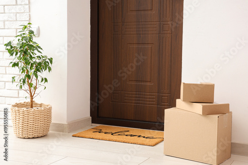 Parcel boxes on mat near do...