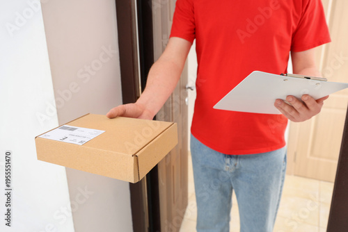 Male courier with parcel an...