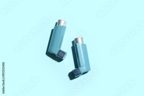 Asthma inhalers on blue bac...