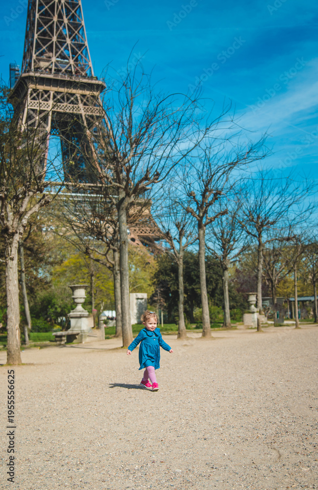 Obraz premium Children in Paris near the Eiffel Tower. Selective focus.