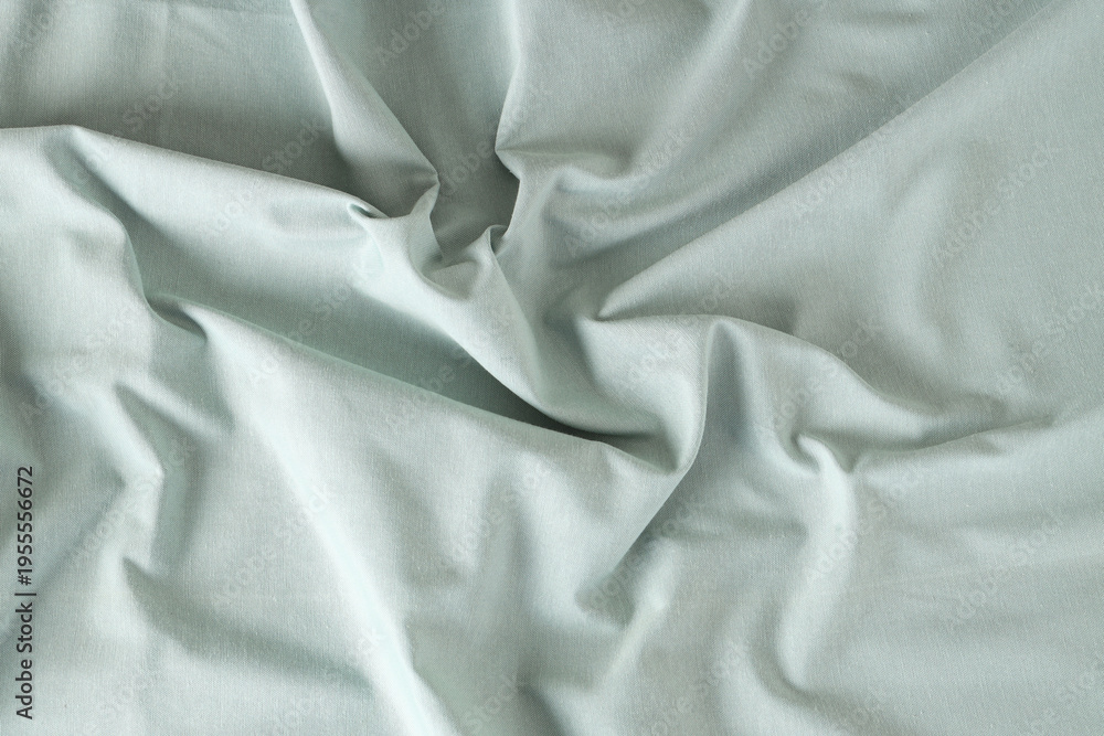 Fototapeta premium Crumpled light green tablecloth as background, top view