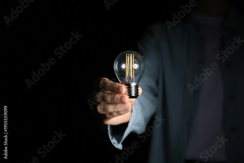 Female hand with light bulb...