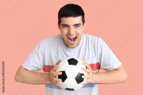 Happy young man with soccer...