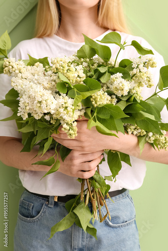Woman holding bouquet of wh...