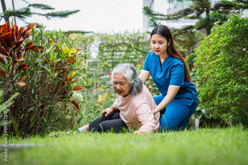 Photography Asian senior woman falling on the ground in the garden while caregiver coming to