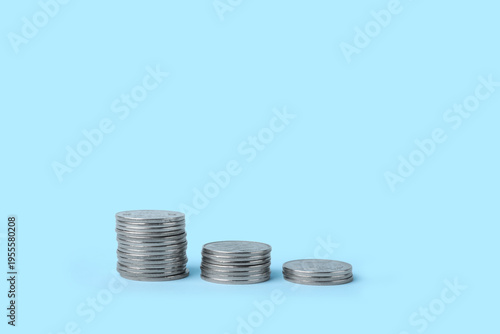 Stacks of coins on blue bac...