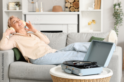 Mature woman with headphone...