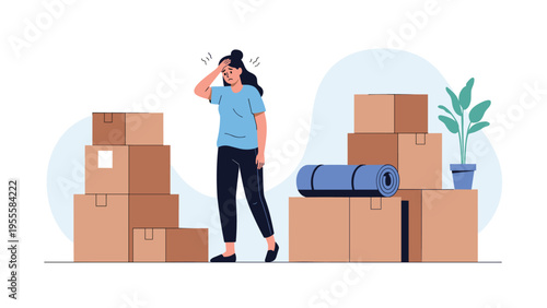 Exhausted and stressed woman standing in a room filled with cardboard moving boxes and a rolled up rug while holding her head in her hand.