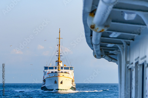 Traditional passenger ferry boat crossing the Bosphorus strait in Istanbul, Turkey at sunset.Front view of a classic Istanbul public transport vapur crossing between Europe and Asia.
