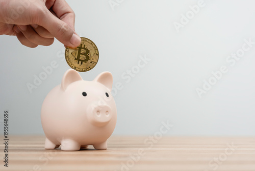 Bitcoin saving Concept. Hand putting bitcoin gold coin into piggy bank for BTC investing, cryptocurrency or digital asset investment future financial planning, wealth management for long term
