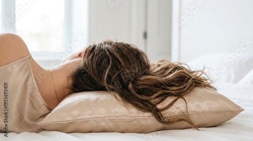 Woman with Long Wavy Hair Sleeping on Silk Pillowcase. Beauty Sleep Lifestyle, Anti-Frizz Hair Care and Luxury Bedding with Copy Space.
