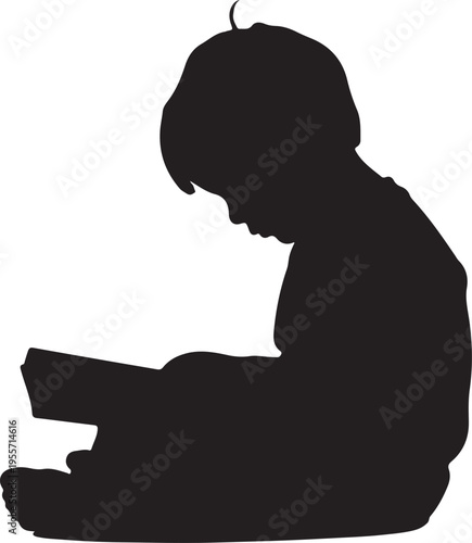 Silhouette of a child engrossed in reading a book while sitting on the floor