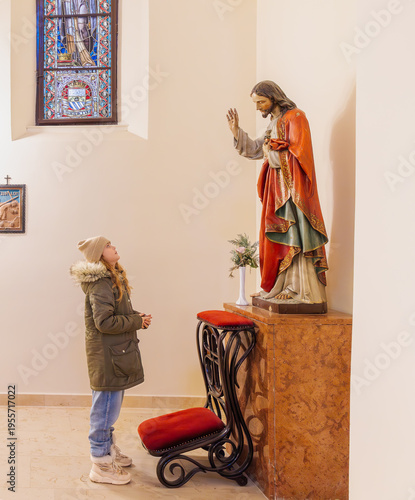 Εκτύπωση καμβά A vertical full length shot of a young girl in a winter parka standing and looki
