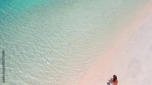 Aerial View of Woman Walking on Tropical Beach with Clear Turquoise Sea