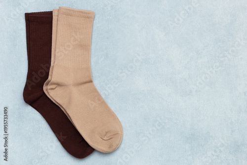 Photos Colored beige and brown socks on gray textured background with copy space