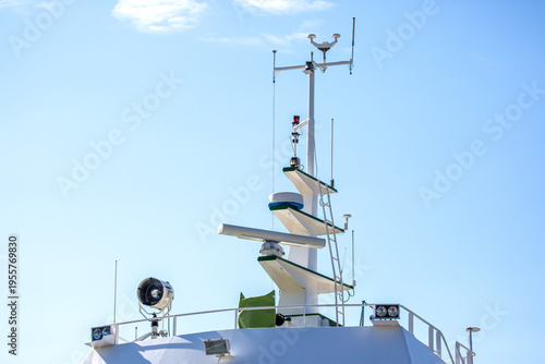Bild auf Leinwand Sailboat mast with navigation equipment and clear sky in a coastal area on a sun