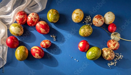 Colorful decorated Easter eggs with feathers on blue background
