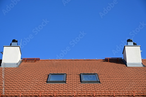 Cuadro en lienzo Red tiled roof with two windows and two ventilation skylights symmetrical archit