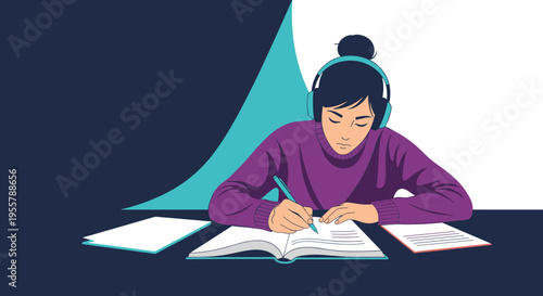 Focused student wearing headphones while writing in a notebook and studying hard from a textbook on a dark desk.