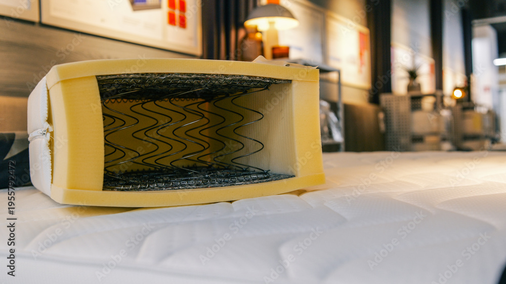 Fototapeta premium Cross section of a mattress showing springs and foam layers for comfort and support