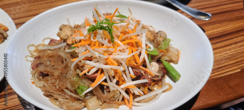 Asian Glass Noodle Bowl Topped with Fresh Bean Sprouts, Julienned Carrots, and Green Onion
