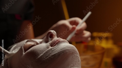 Relaxing spa facial treatment with soothing white mask application on face and neck, highlighting skincare pampering, wellness, and calming beauty ritual