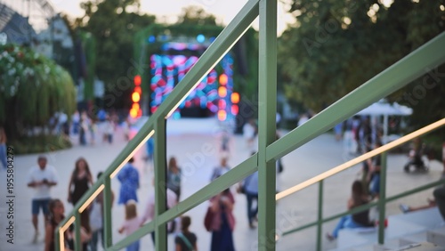 Obraz na plátně Festival stage lights illuminating a crowd gathering at an outdoor park event