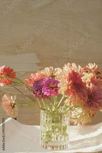 Fresh cut flower bouquet of zinnias from garden, copy space on vertical background.