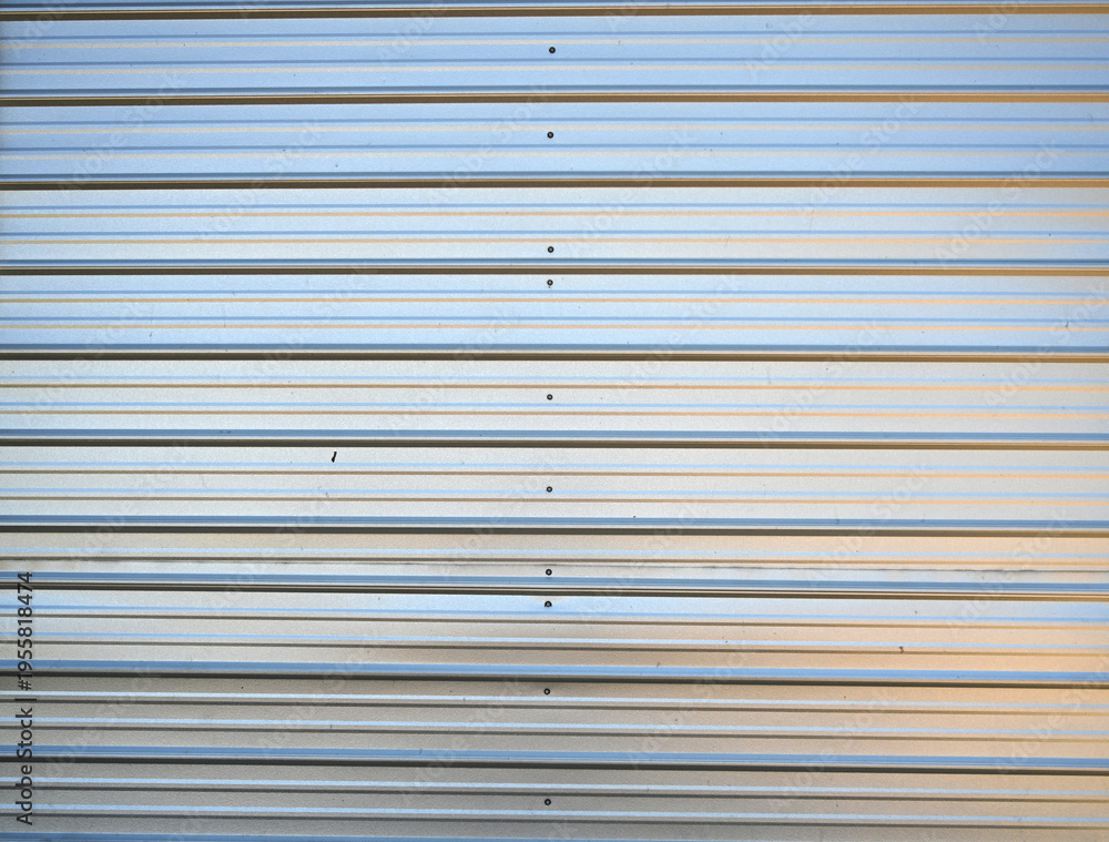 Fototapeta premium Close‑up texture of shiny silver corrugated tin siding 
