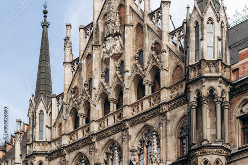Munich, Germany - April 15, 2025: Neo Gothic facade of the New Town Hall (Neues Rathaus) with detailed arches, sculptures and tower on Marienplatz in the historic center of Munich, Germany