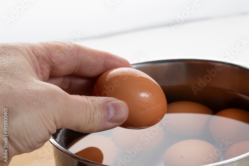 We cook brown eggs in a pot.