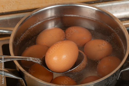 We cook brown eggs in a pot.