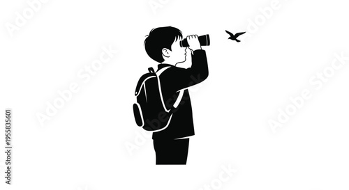 Young boy looks through binoculars at a bird striking silhouette