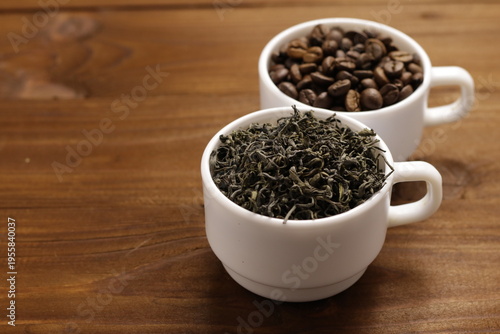 Cups with coffee and tea on wooden table