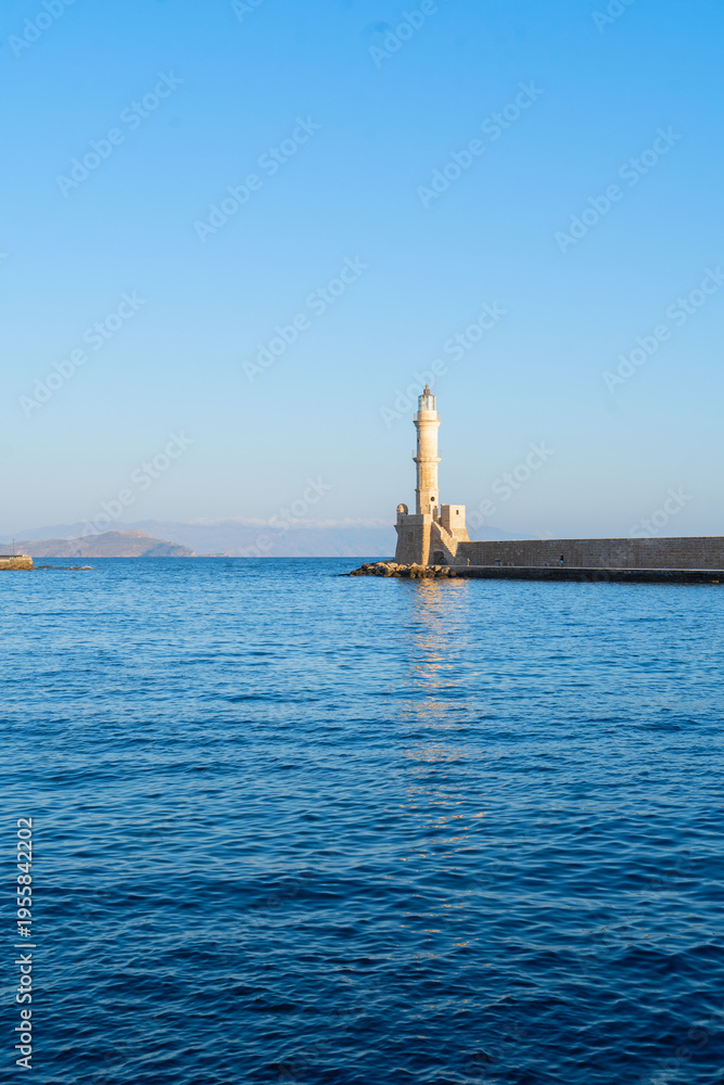 Fototapeta premium bay of Chania with sea and lighthouse at sunny summer sunset, Crete, Greece, web banner format