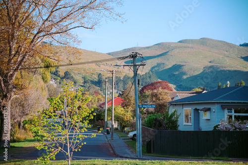 Christchurch, New Zealand: A quiet residential street in the St. Martins neighborhood with suburban houses and the Port Hills in the background.