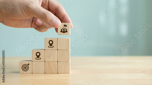 Hand placing a block, building a conceptual staircase of career success. Visualizing strategic professional development, educational achievement, and collaborative goal attainment