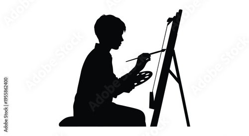 Young artist painting at an easel a striking black silhouette